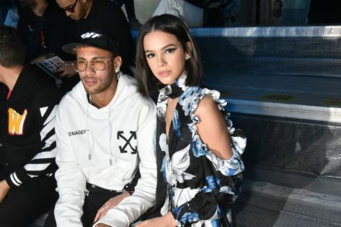 Bruno Marquezine in a black dress poses a picture with Neymar.
